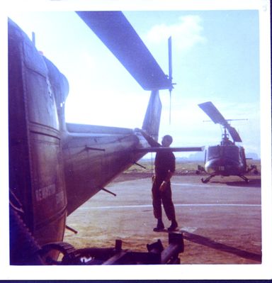 Sgt__Mike_Swiatecki_Preflighting_An_HML167_Huey_Large.jpg